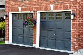 Two car garage with brown steel doors on brick facade