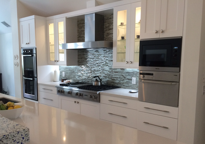 Kitchen remodel using blond wood cabinets and SS appliances