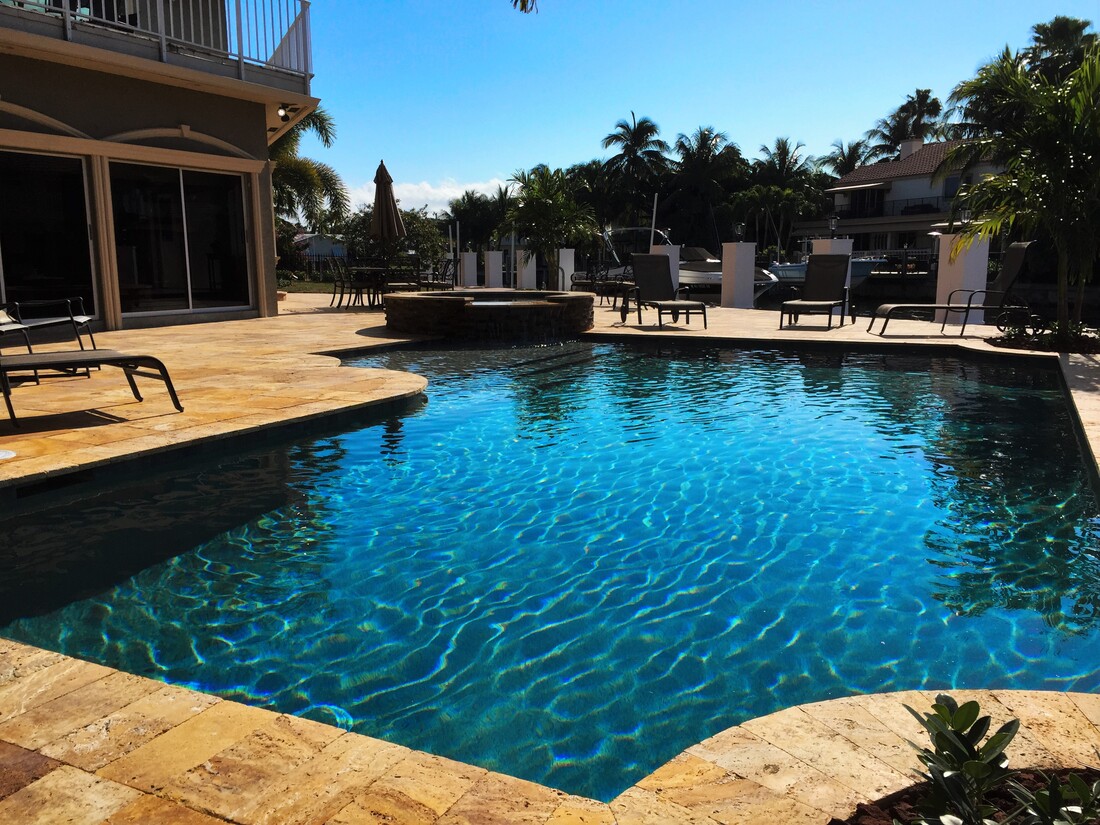 Abstract formed pool with stone deck surface