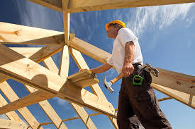 Framing carpenter looking at the crossbeams of new home