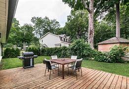 Ground level wooden deck with BBQ and table