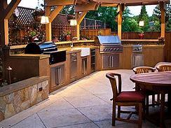 Outdoor kitchen featuing stone flooring and barn pole covering