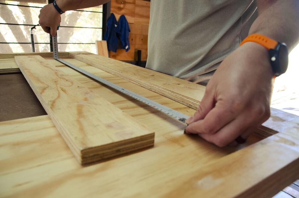 Carpenter measuring work on table top