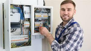 Smiling electrician showing off panal box wiring