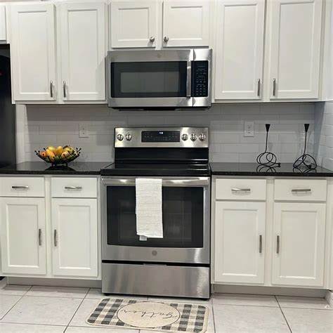 White kitchen cabinets featuring SS appliances