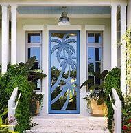 Entry door featuring palm trees ovelaid on glass