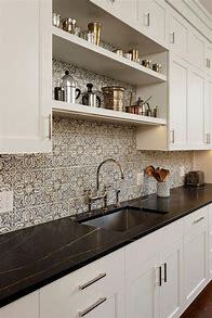  Designer used White wood kitchen cabinets over tiled backsplash