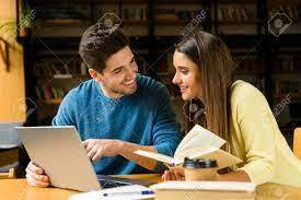 Smiling couple looking at their computer