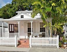 Small white house with white picket fence