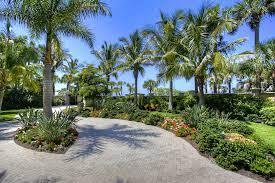 Landscaped property with palm trees and circular driveway