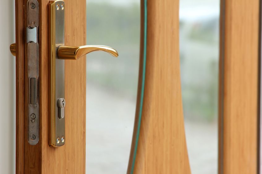 Door lock on wooden door with glass panels