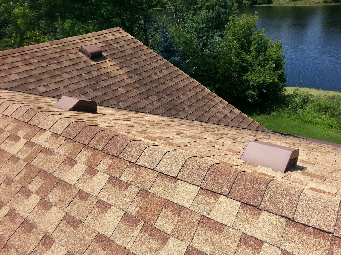 View of rooftop with sample of tan roof shingles